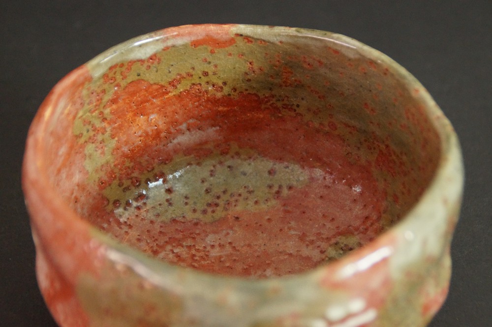 Close-up of the red-green glaze on the inside of the chawan