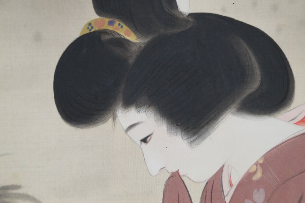 Primo piano dell'elaborata acconciatura della dama di profilo nel kakemono dama in kimono presso il laghetto del giardino