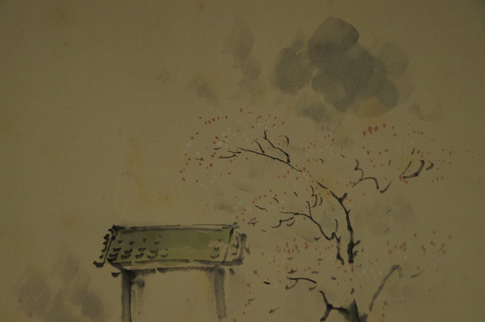 Close-up of the torii roof against the ink cloud and the blooming tree