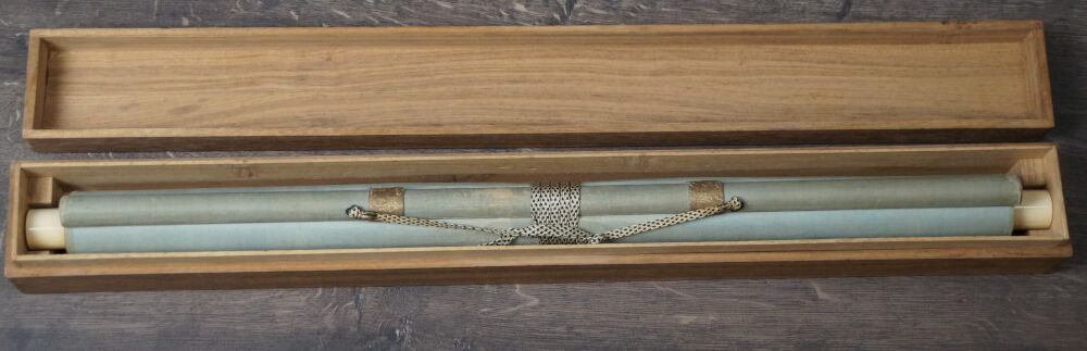 Opened storage box with the rolled-up hanging scroll Rising Sun