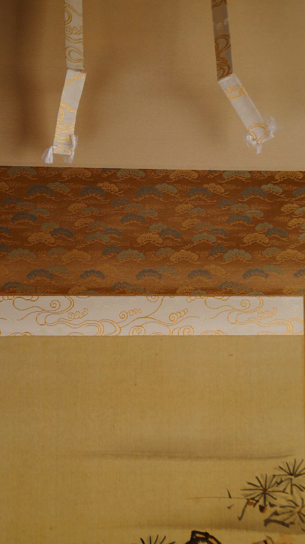 Detail der Montierung des Kakemono mit goldbraunem Kiefernmuster-Brokat und Aufhaengebaendern