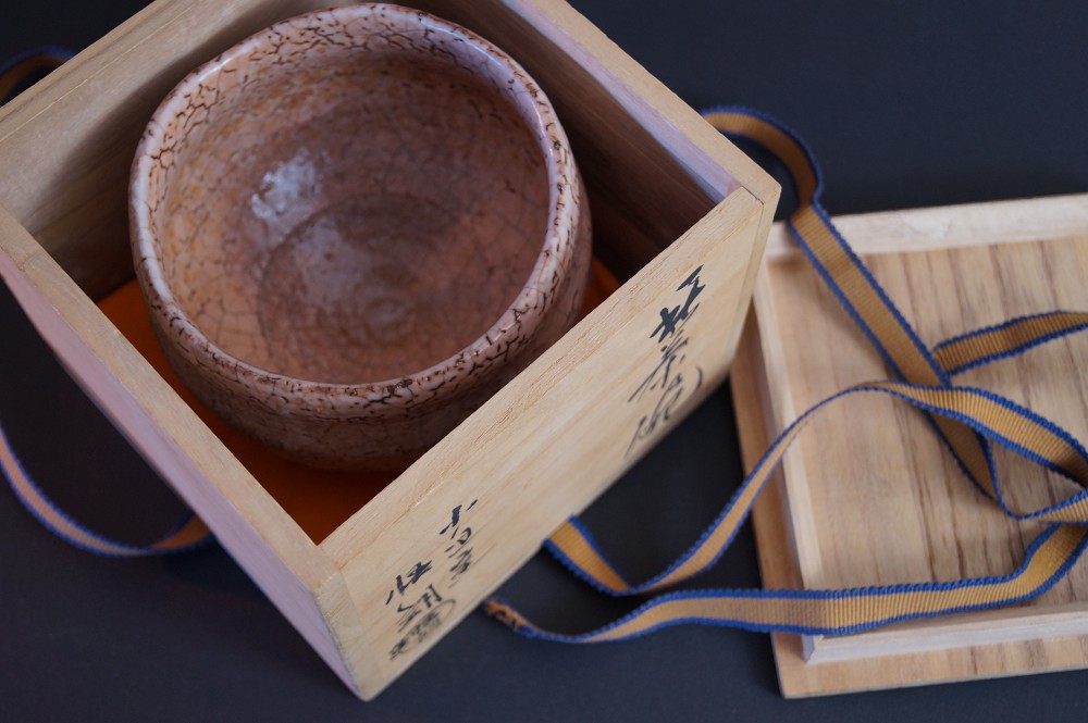 The tea bowl lying in the opened storage box with signature