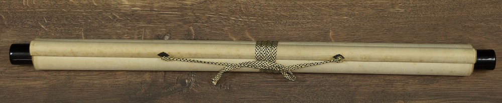 Rolled-up kakemono tied with cord, with wooden jikusaki