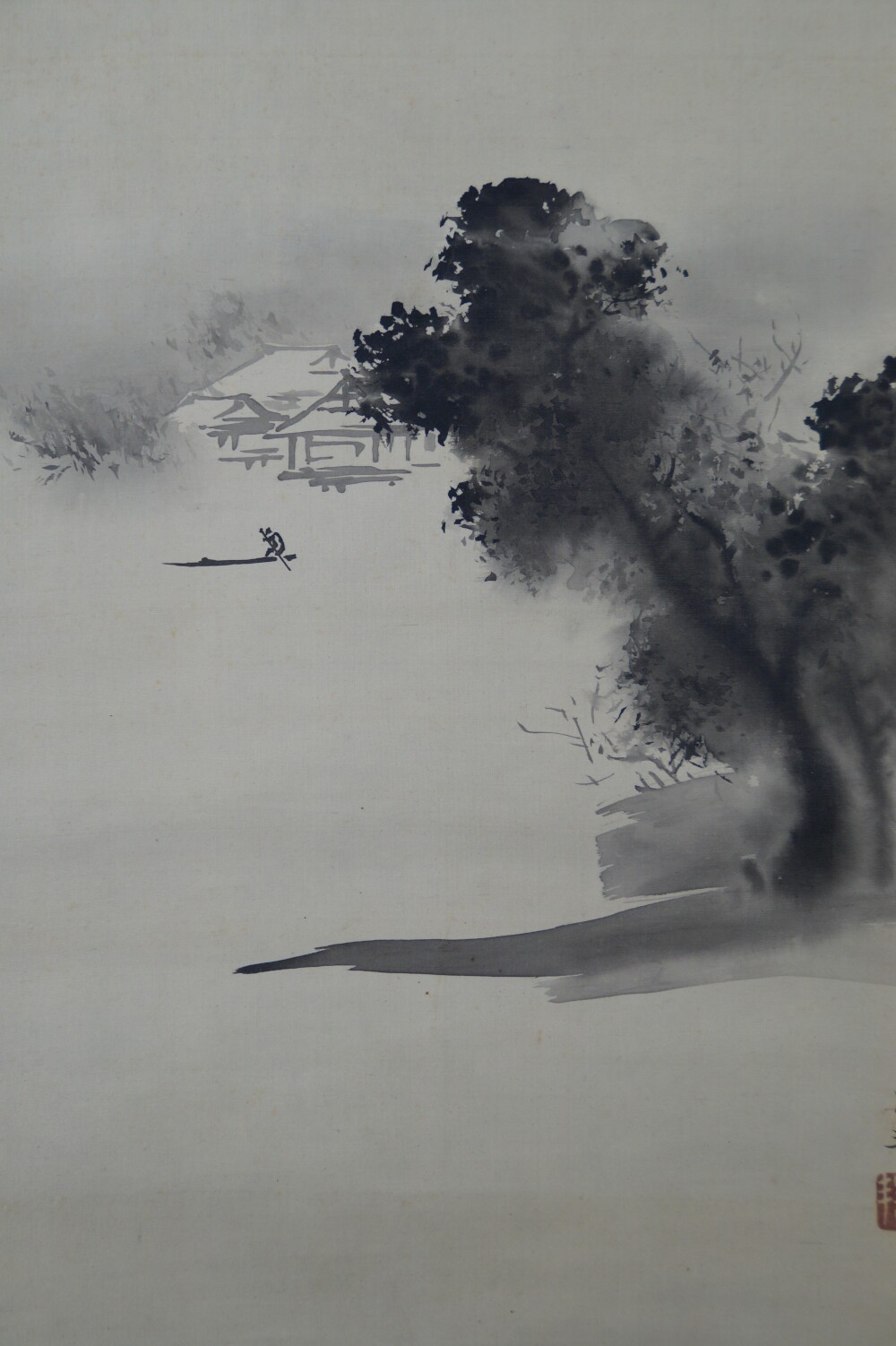 Further close-up of the house on the shore with trees and fishing boat and artist's seal in the hanging scroll House in the Fog on a Mountain Slope by Hashimoto Gaho