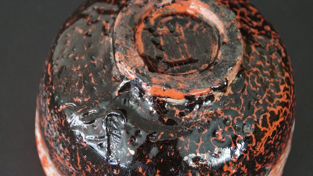 Detailansicht des Standfusses mit eingepraegtem Kuenstlersiegel der Chawan Teeschale aus Raku-Keramik