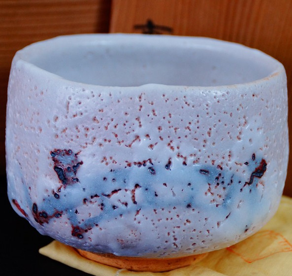 Chawan aus Shino-Keramik von Jyuzo Sato mit weisslich-lavendelfarbener Glasur vor der Aufbewahrungsbox