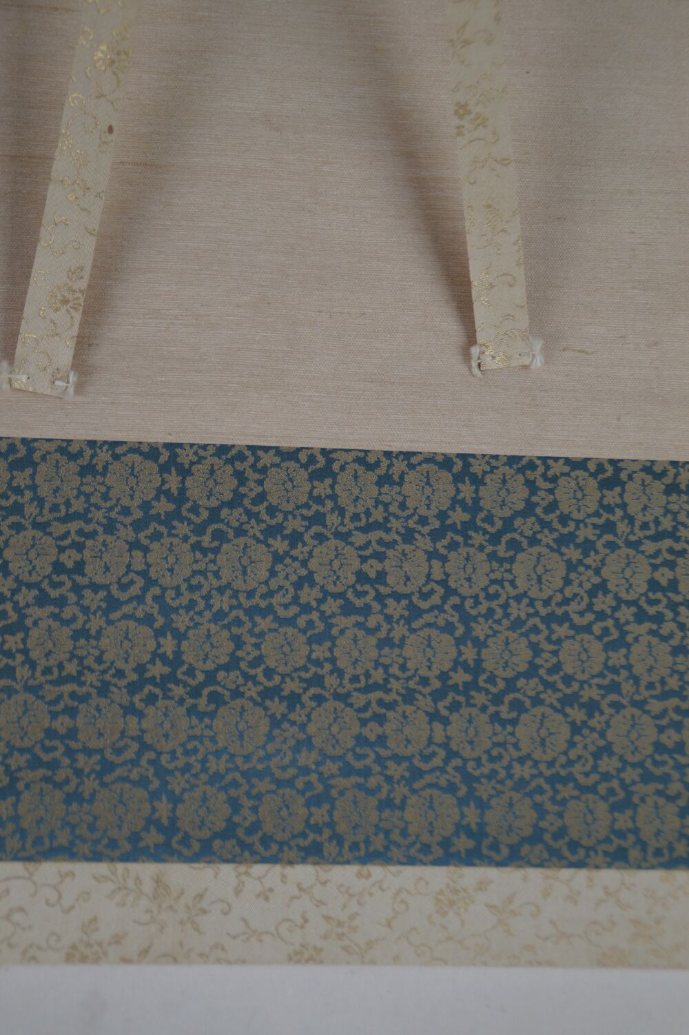 Detail View of the Blue Brocade Silk Mounting with Hanging Cords of the Kakemono Puppy in the Evening Glow under Pines