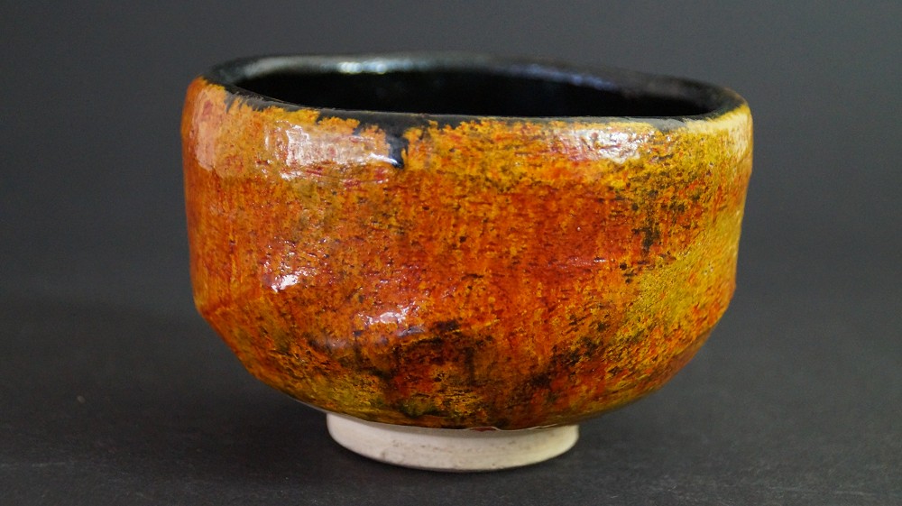 Vue de côté du chawan en céramique de Tobe avec glaçure couleur ambre et bord intérieur noir par Haryoku
