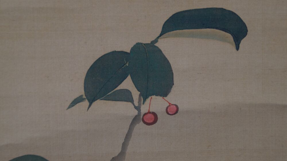 Close-up of the dark green leaves with red berries in the kakemono Rising Sun