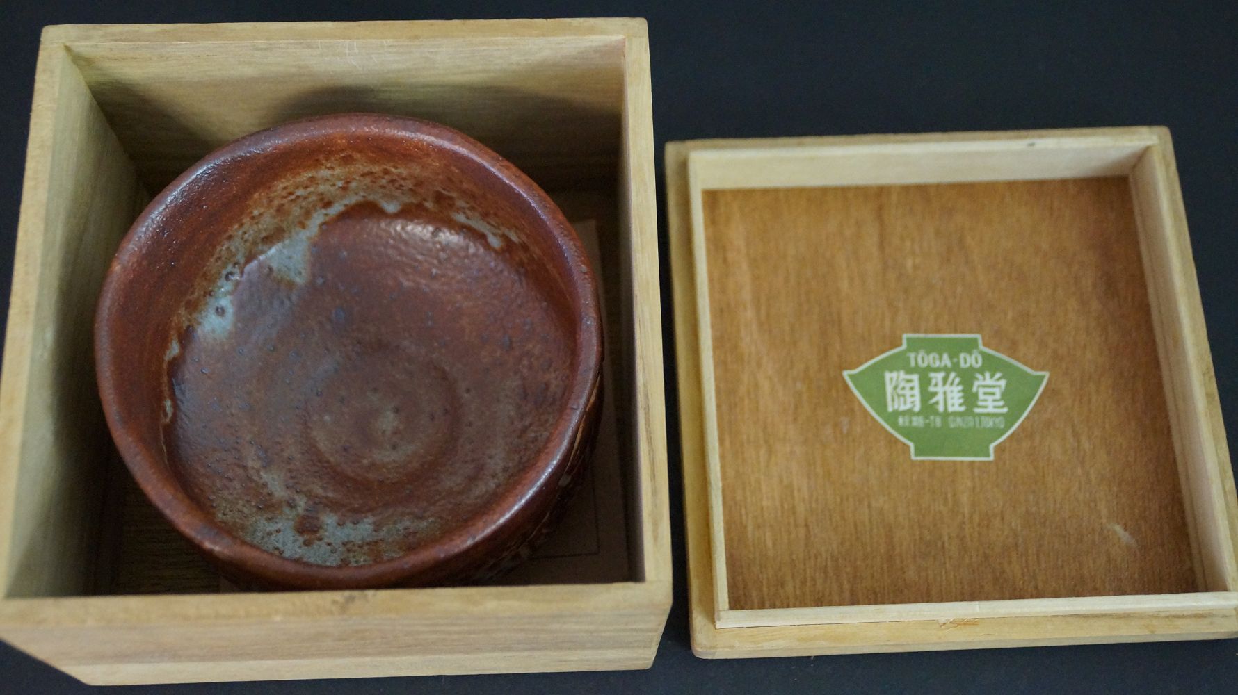 Chawan Teeschale in der geoeffneten Aufbewahrungsbox neben dem Deckel mit Haendlerlabel Toga-do