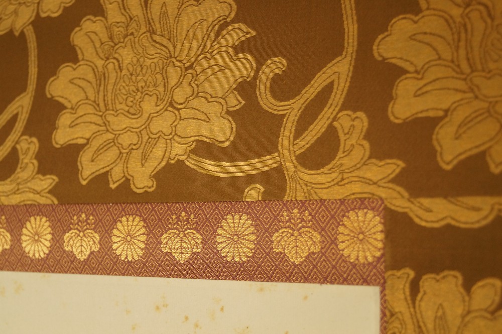Kalligrafie Kalavinka Nahaufnahme der goldenen Brokatmontierung mit Chrysanthemenmuster Montierungsdetail
