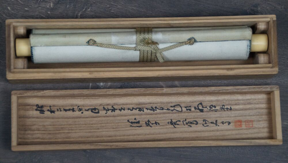 Geoeffnete Aufbewahrungsbox mit zusammengerolltem Kakemono Japanische Aubergine