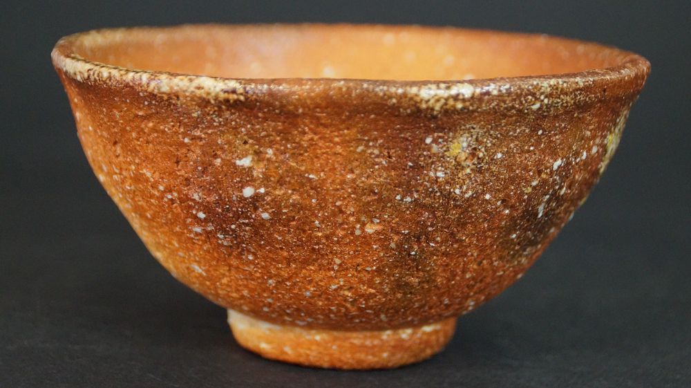 Otra vista del chawan de cerámica de Shigaraki con superficie moteada y borde claro